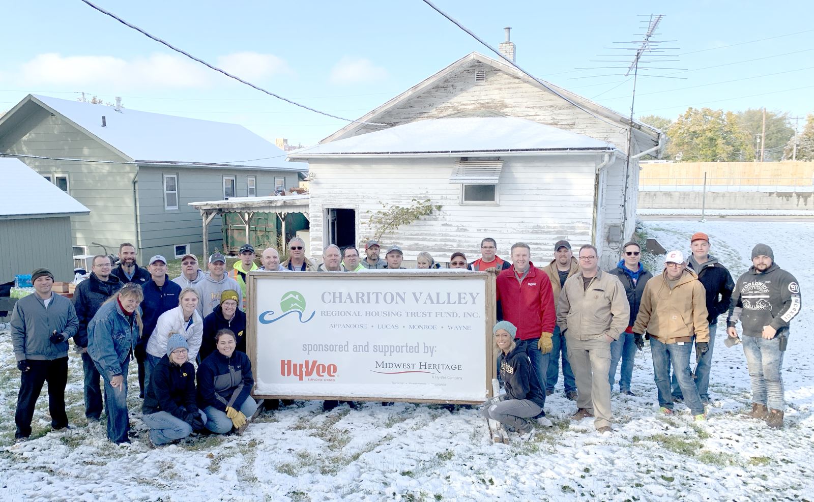 Group of employees in front of a house